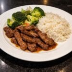Easy beef and broccoli stir fry with rice served on a white plate for a simple weeknight dinner.